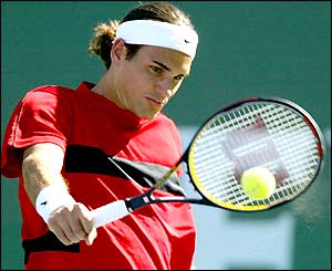 Roger Federer hits a backhand
