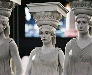 Young women dressed as classical Greek style pillars
