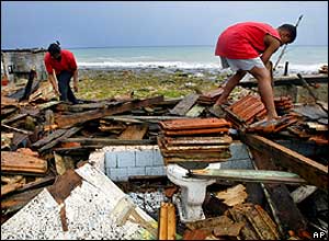 Cuban Mirta Estrada (left) and her son Yosel Fuente survey the damage in Baracoa, western Cuba