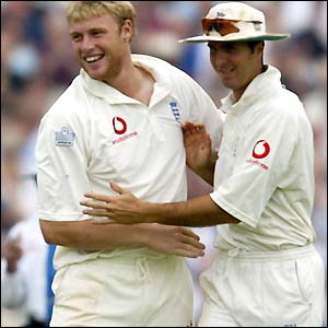 Andrew Flintoff celebrates his third wicket with Michael Vaughan
