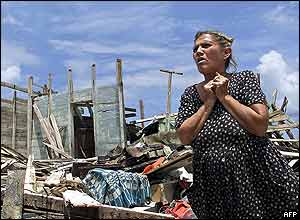 A Cuban woman stands by the ruins of her house, destroyed by the hurricane