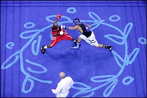 Urkirbek Haydarov (blue) lands a punch against Isaac Ekpo