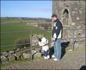 Linda Jones' young daughter Cara Elin and husband Mark on the walls of Beaumaris Castle