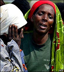 Refugees weep at the sight of a dead relative.