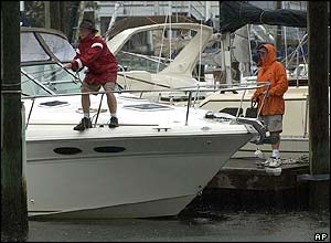 Dock master Bill Whaley (left) tightens a line on a boat as he prepares for the arrival of Hurricane Charley in Wrightsville Beach, North Carolina