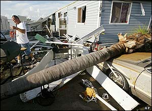 Duane West searches for items in front of his home in Punta Gorda, Florida