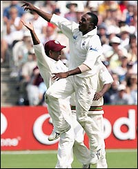 Dwayne Bravo celebrates a sharp catch off his own bowling as the England tail collapse