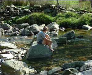 Darran Jones' girlfriend resting by the river after hiking up Snowdon
