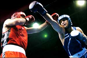 Vanes Martirosyan of USA avoids a right thrown by Benamar Meskine (R) of Algeria in their preliminary 69 kg Welterweight Olympics match at the Peristeri Boxing Hall 