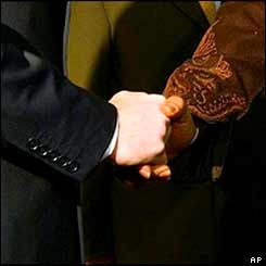 Hands of Tony Blair (left) and Muammar Gaddafi 