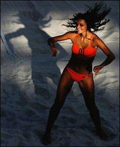 A woman performs a dance on the sand