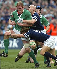 Paul O'Connell is tackled by Scotland's Chris Cusiter and Simon Webster