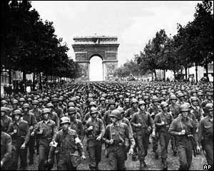 Vehicles and troops from both French and US forces parade along the Champs Elys�es