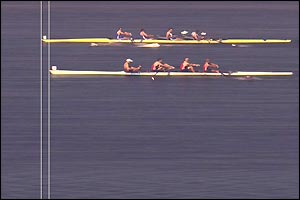 Great Britain's yellow boat crosses the line a fraction ahead of the white Canadian boat