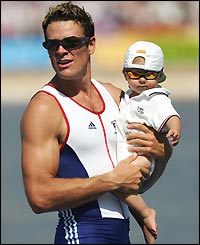 James Cracknell celebrates his second Olympic gold medal with his son Croyed