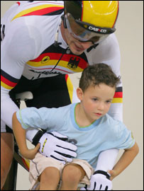 German Jens Fiedler carries his son on his bike