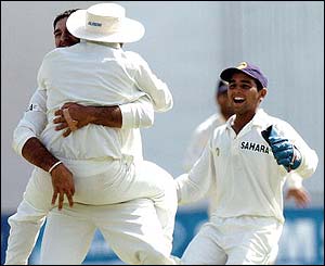 Virender Sehwag is lifted by his team-mate Yuvraj Singh following the dismissal of Yasir Hameed