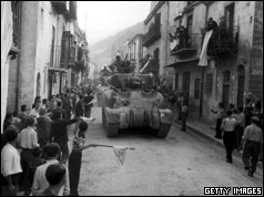 Residents of Palermo, Sicily, line the streets to greet the American Sherman tanks after the town had surrendered to the Allies.