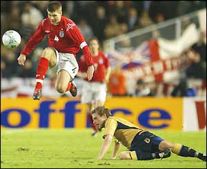 Steven Gerrard hurdles a tackle from Anders Svensson