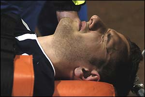 Scotland defender John Kennedy is stretchered off