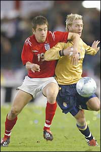 England sub Joe Cole tries to cause problems for the Swedish defence