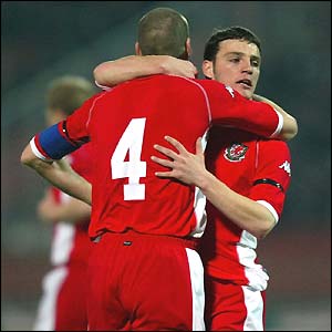 Jason Koumas celebrates his equaliser for Wales
