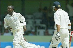 Fidel Edwards takes the wicket of Mark Butcher for five 