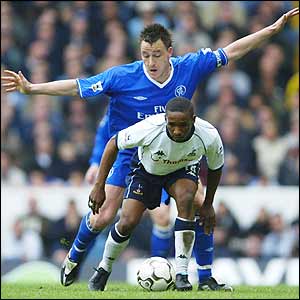 Jermain Defoe is challenged by John Terry