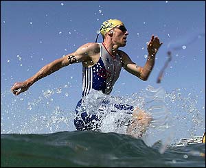 Andrew Johns starts the run to the beach after the 1500m swimming event