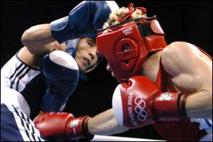 Jerome Thomas (R) of France and Tulashboy Doniyorov (l) of Uzbekistan exchange blows during their flyweight (51 kg) Olympic Games quarter-final match 
