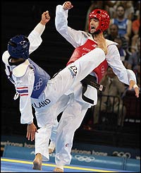 Sutthikunkarn Ussadate of Thailand clashes with Michalis Mouroutsos of Greece