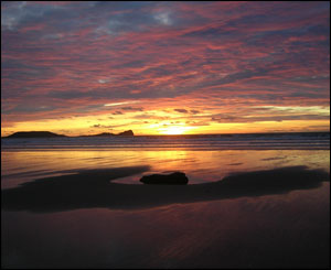 Photograph by Ioan and Jo from Penarth taken late afternoon in January from Rhosili Beach looking out to Worms Head.