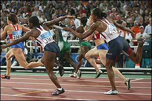 Lauryn Williams (left) and Marion Jones fumble the baton