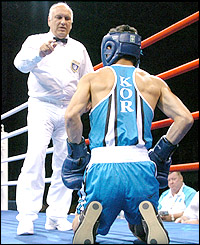 South Korea's Baik Jong-sub is given the count by the referee after being felled by Khan in the quarter-finals