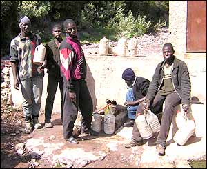 Migrants near water pipe