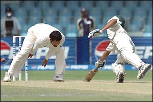 India's Sachin Tendulkar tries unsuccessfully to run out Umar Gul