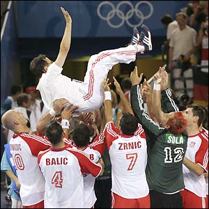 Croatia's players celebrate with their coach Lino Cervar