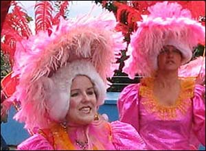 Two people wearing pink costumes