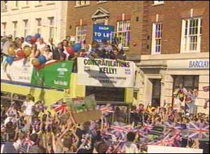 Double Olympic winner Kelly Holmes is being paraded through her home town, the Kent village of Hildenborough.