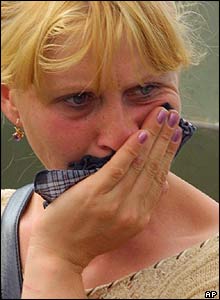A woman waits anxiously outside the school in Beslan