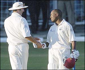 England's Michael Vaughan congratulates Brian Lara on his 300