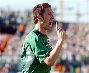 Robbie Keane celebrates scoring from the spot