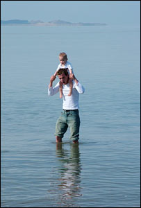 Dave, braving the cold high tide on Llanelli Beach with Brandon, sent by Neil Hopkins 