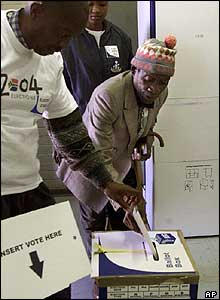 Election official helping an old man to vote