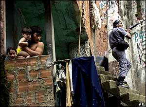 Family watches a policeman in the Rio slums