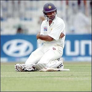 Asif Kamal looks on in dismay as his batting partners are out