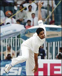 Anil Kumble bowls on his way to taking four wickets in the innings