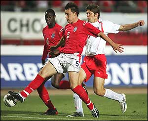 John Terry (centre) clears the ball from Grzegorz Rasiak (right) 