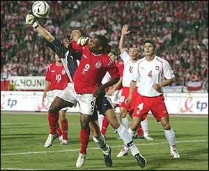 Goalkeeper Jerzy Dudek comes off his line to clear the ball from Defoe