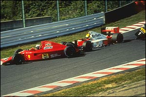 Ayrton Senna crashes his McLaren into Alain Prost's Ferrari at 160mph at the start of the 1990 Japanese Grand Prix
